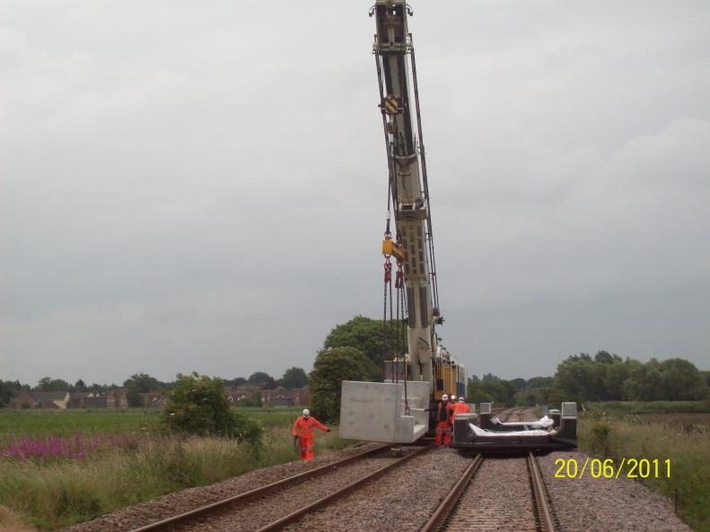 Kirow Crane lifting moving the concrete units down to the Bridge.