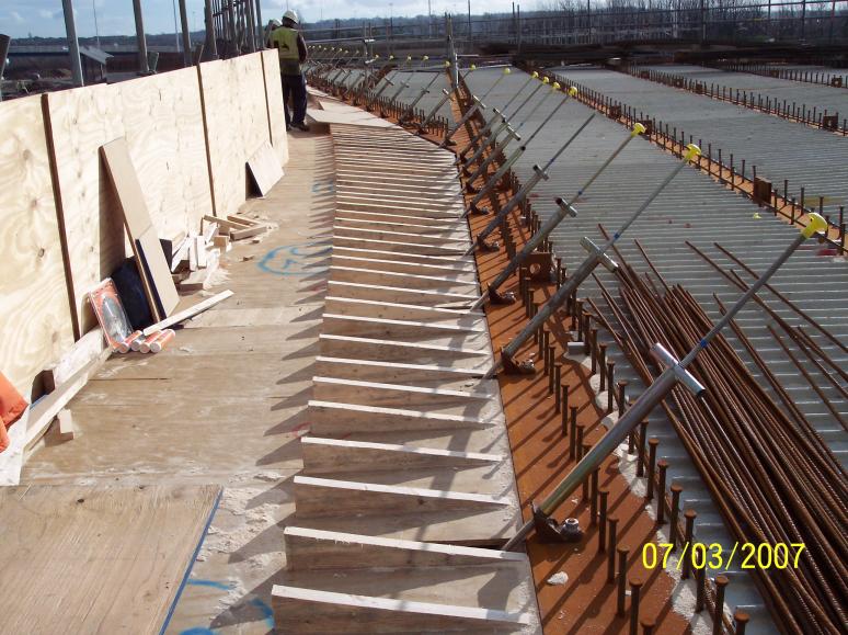 Cantilever angle sections cut to follow the parapet profile
